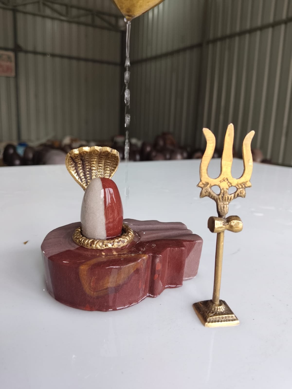 Narmadeshwar Shivling shown in hand for size reference